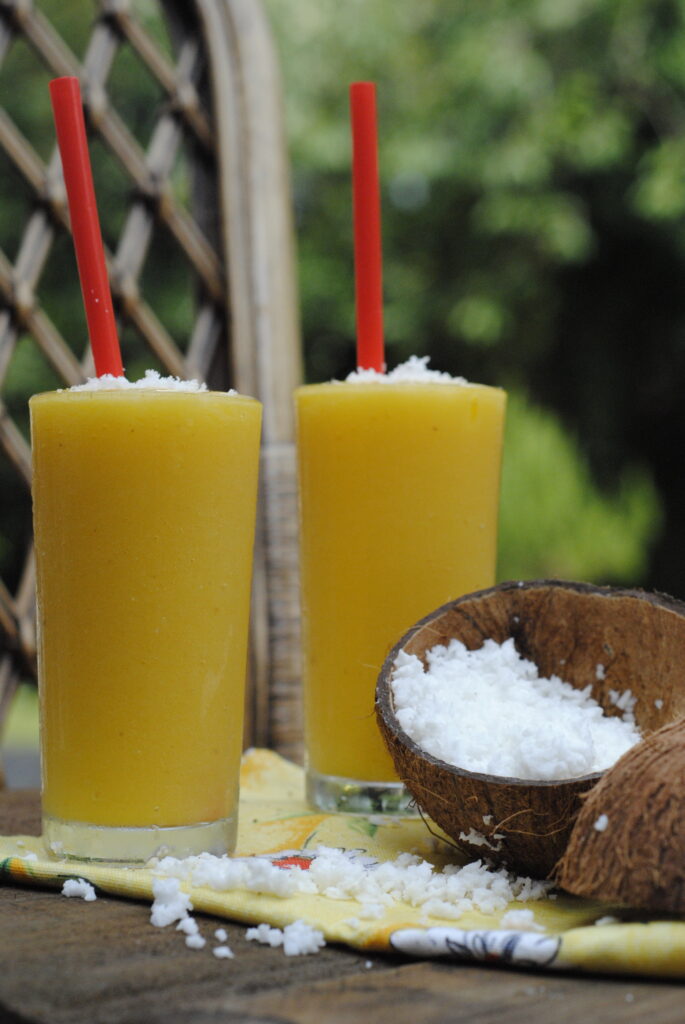 Two glasses with refreshing mango and coconut smoothie