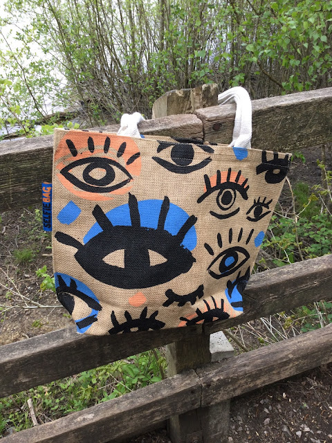 Jute bag with selfie stick and accessories.