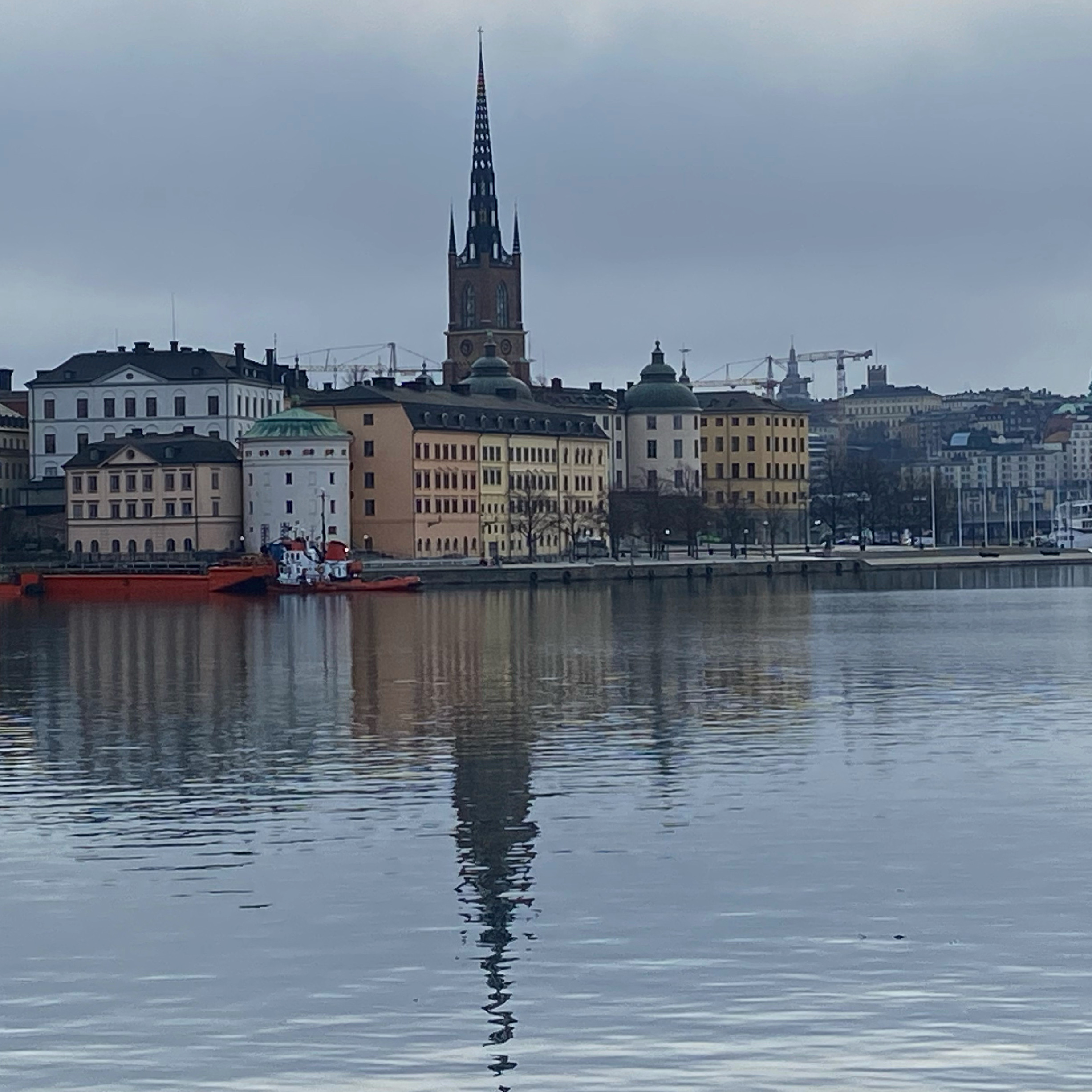 Stock Harbour, old town , Gamla Stan , photo of the tower and reflection in water.
