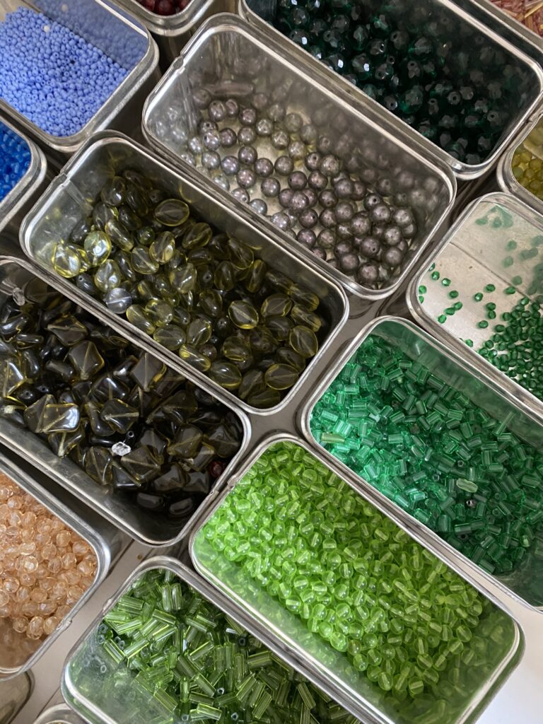 Collection of blue, red, orange and assorted coloured beads