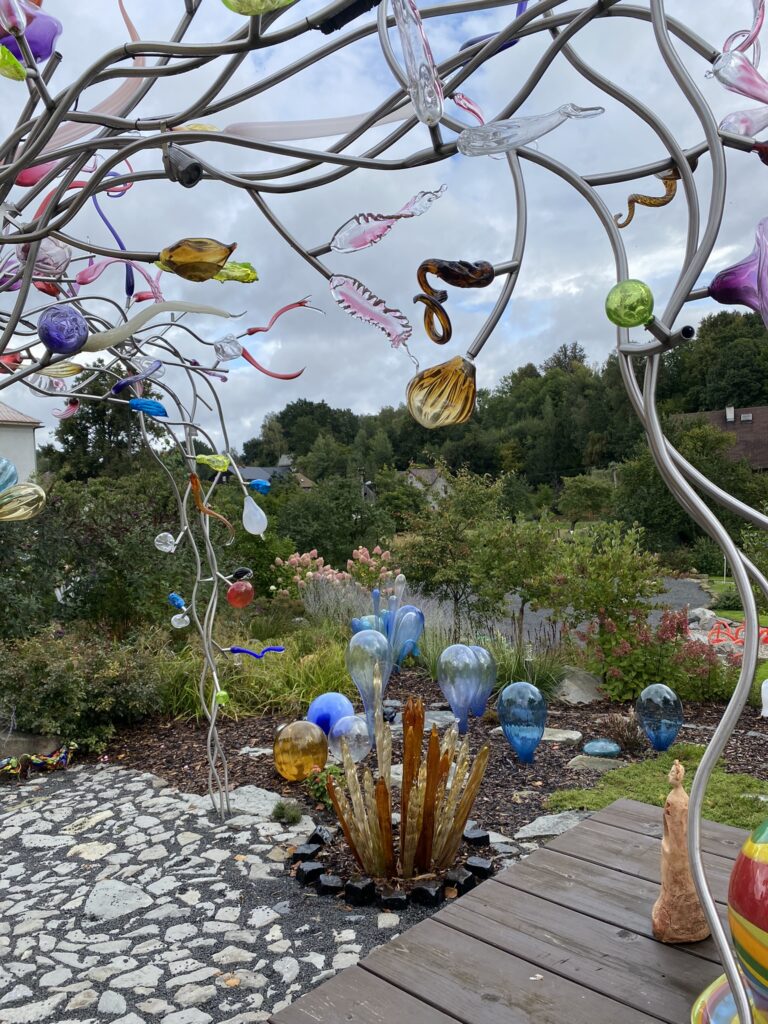 Decorative hand blown glass sculptures in pretty colours in an arch at the Crystal Garden at Cvikov Glass Works