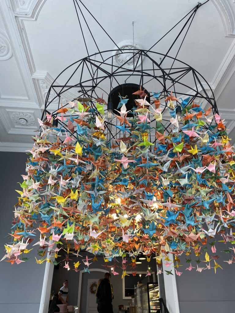 Colourful paper Origami birds hanging from ceiling at at Sorry pečeme jinak (Sorry, We Bake Differently) Cafe in Brno Czech Reubl