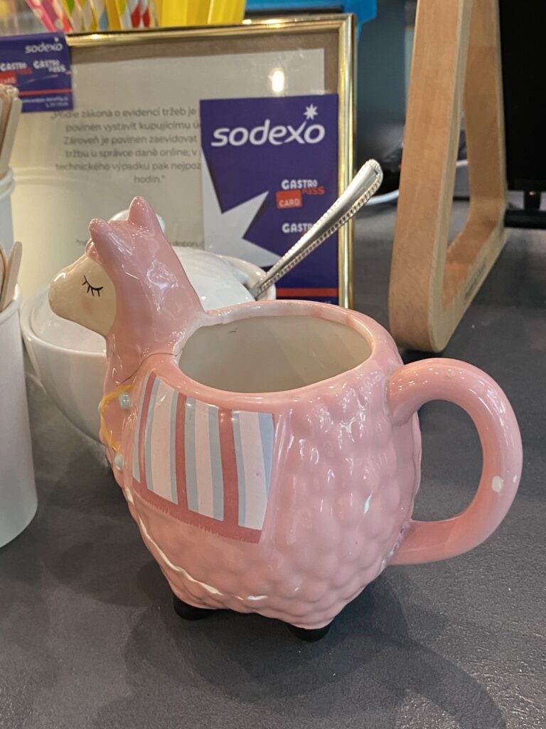 Pink llama shaped coffee cup at Yummy Lamy Cafe Brno