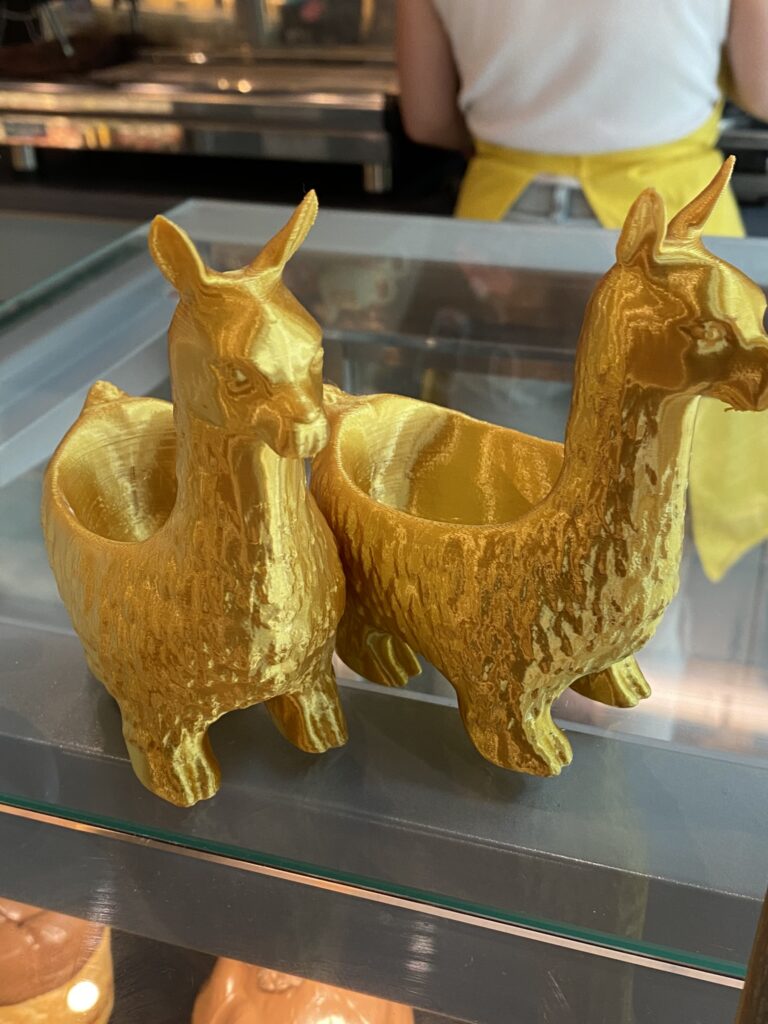 Gold llama shaped eggcups at Yummy Lamy Cafe Brno