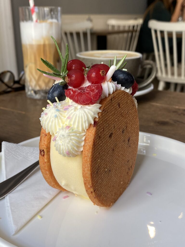 Icecream sandwich cake with biscuit and cream and raspberry decoration at Sorry pečeme jinak (Sorry, We Bake Differently) Cafe in Brno Czech Reubl