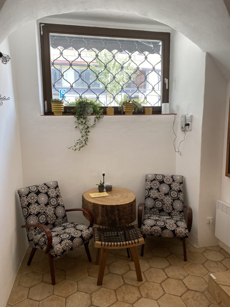 Black arm chairs andcoffee table sitting inside PF Cafe Brno Czech Republic