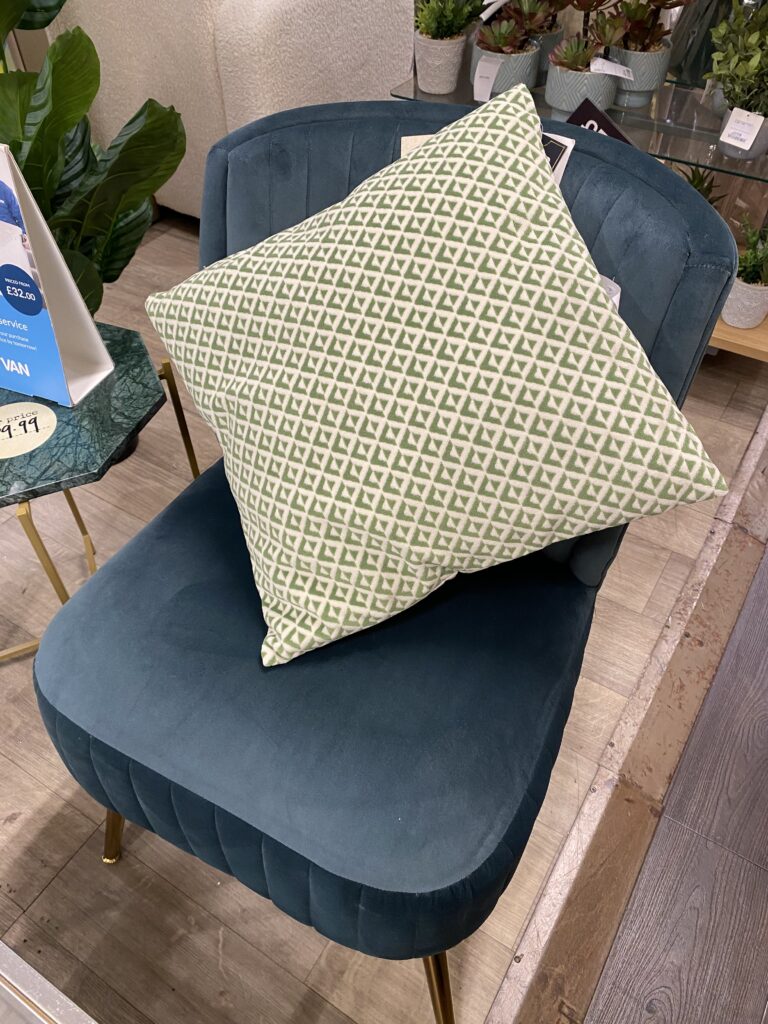 Mosaic design cushion on blue chair