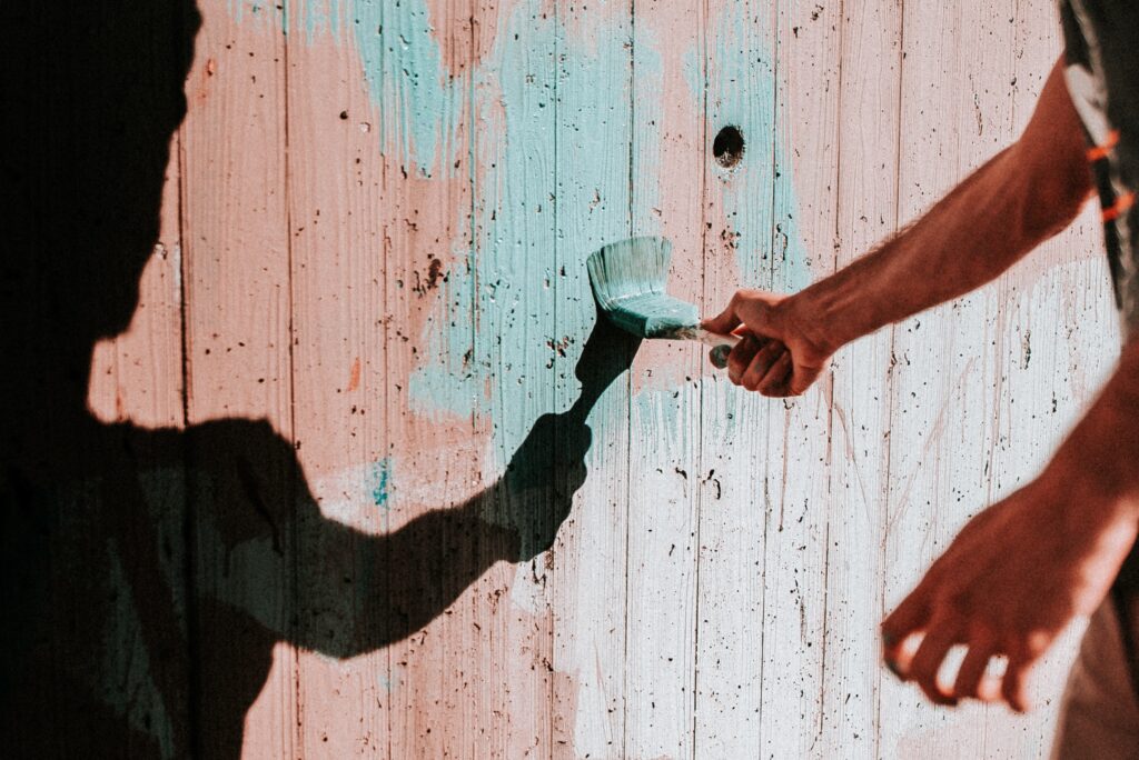 Painting the garden wall with blue paint
