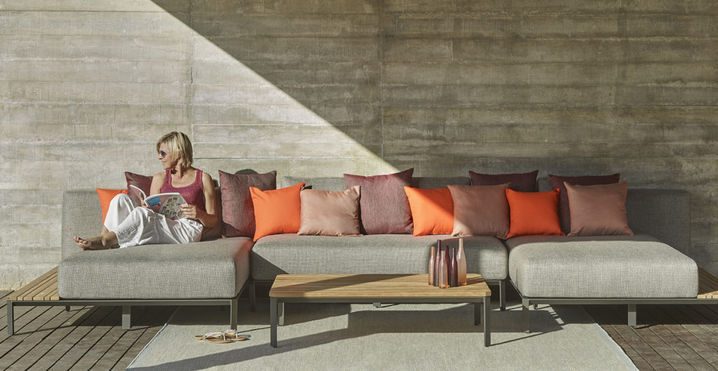 garden sofa with table and  cushions of rust, slate and terracotta colours creating Moroccan vibe