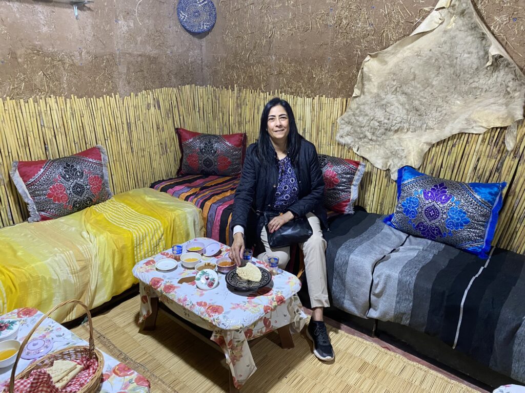 Enjoying traditional Berber breakfast in Bedouin tent on a trip to Atlas Mountains Morocco.