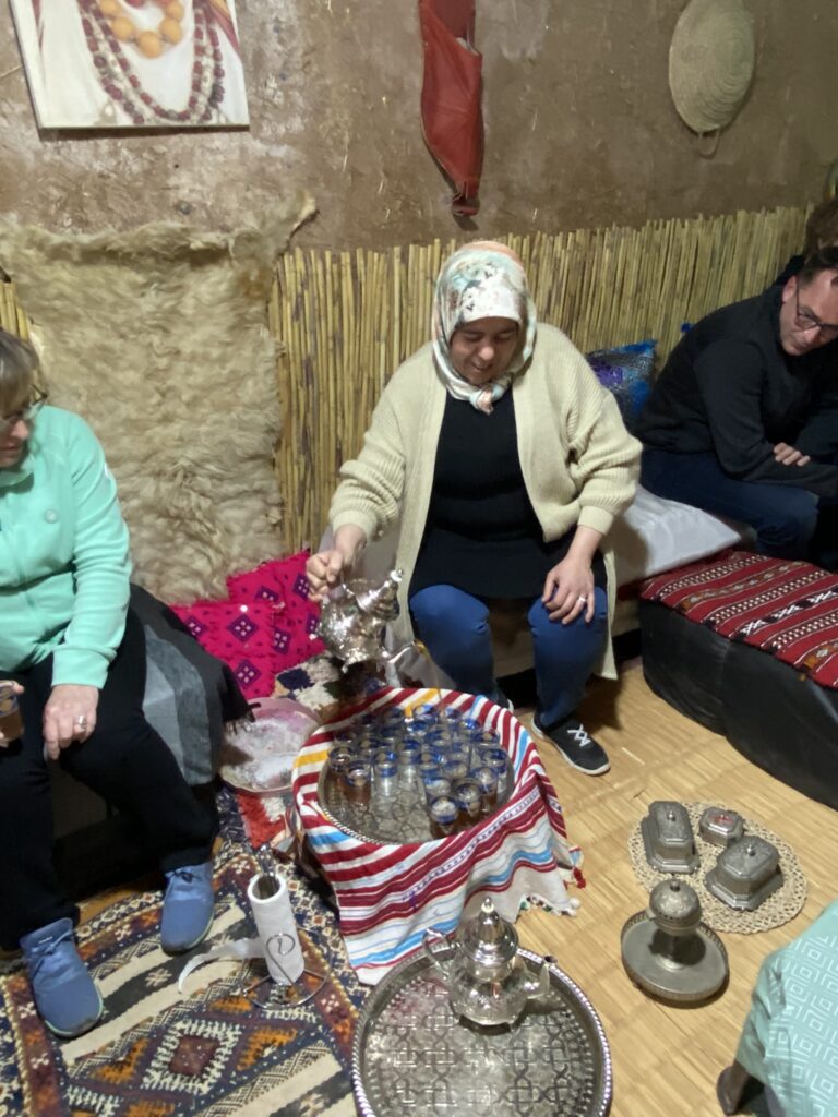 Local Moroccan lady making and serving Moroccan mint tea