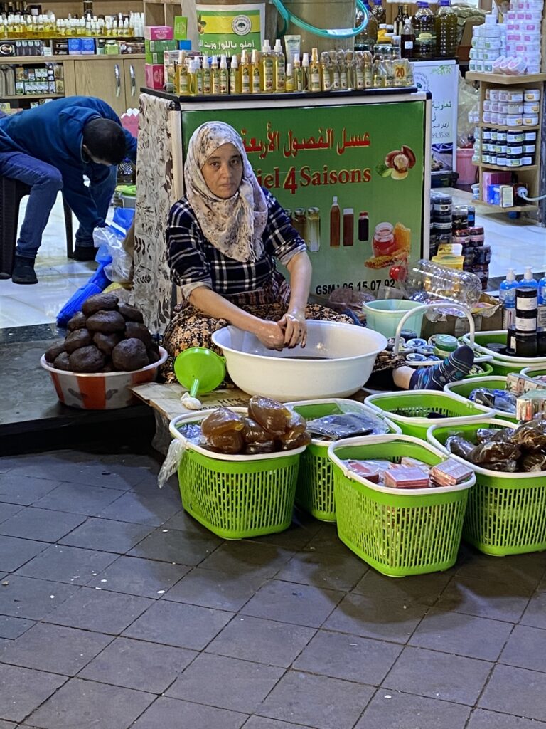 Moroccan lady extracting Argan oil in Souk Al Had