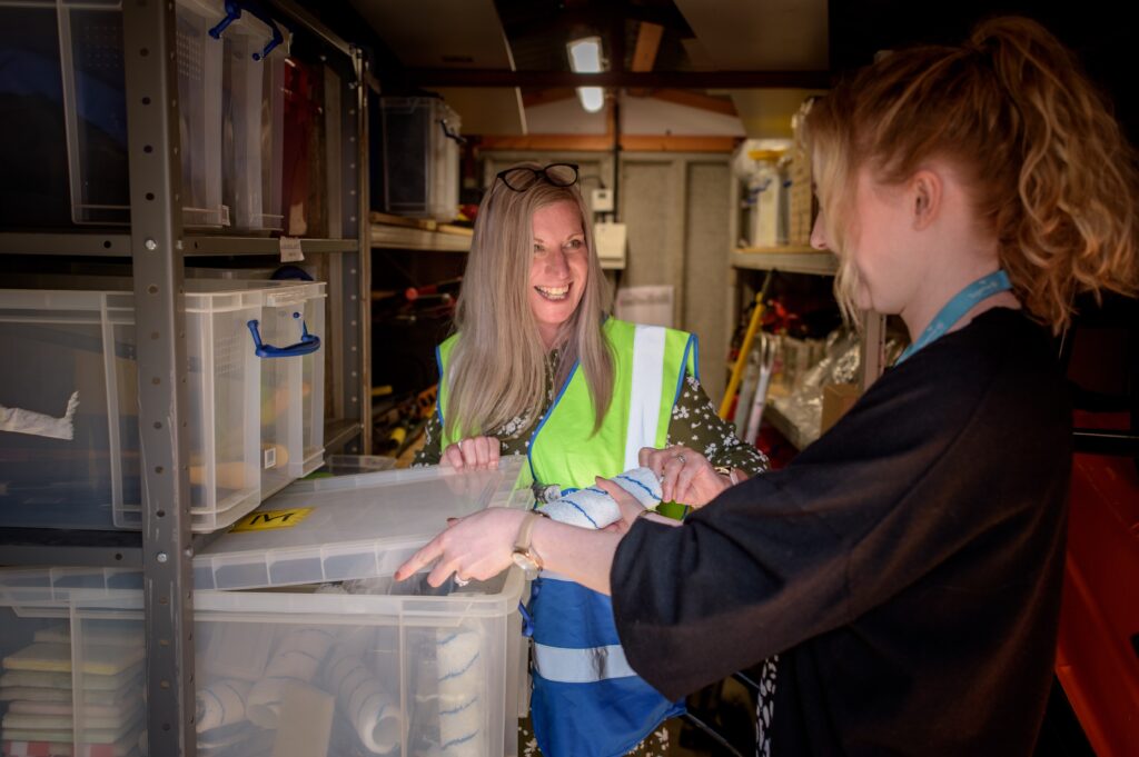 Selving in storage unit with stacked items and boxes and helpers