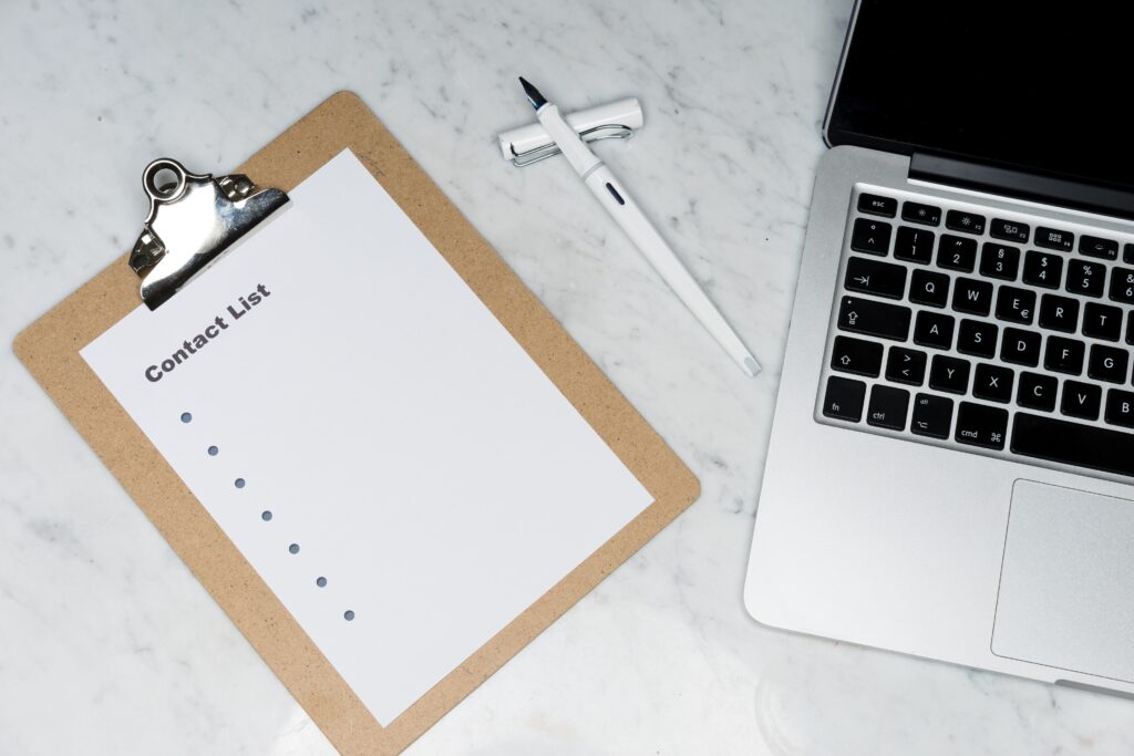 Lap top and clipboard with inventory list.