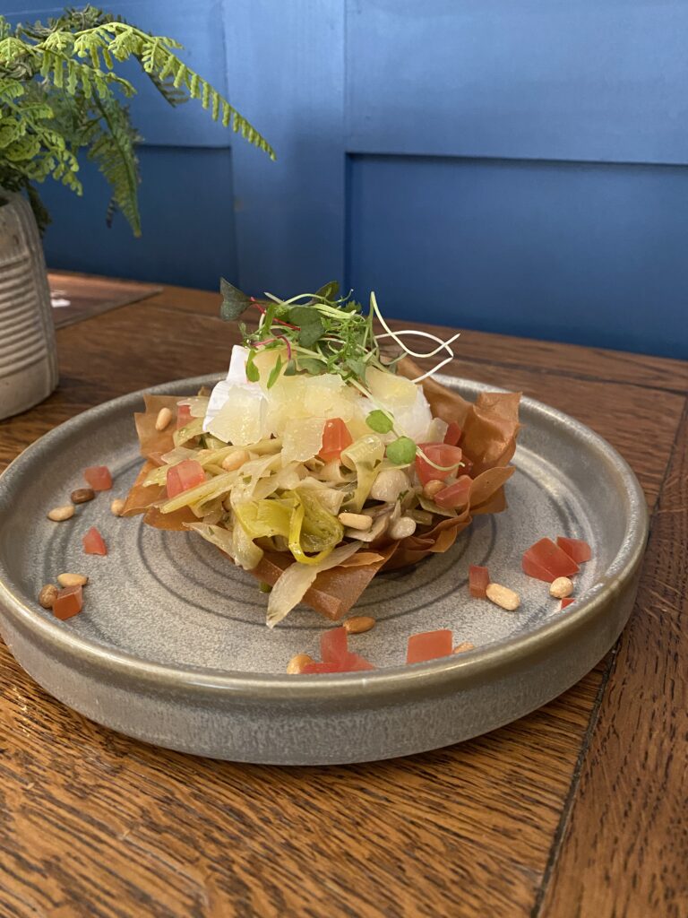 Appetiser at Duke on the Test Inn . Wild mushrooms and leek ragu filo basket, poached egg, tomato concasse, pine nuts, and topped with old Winchester shavings