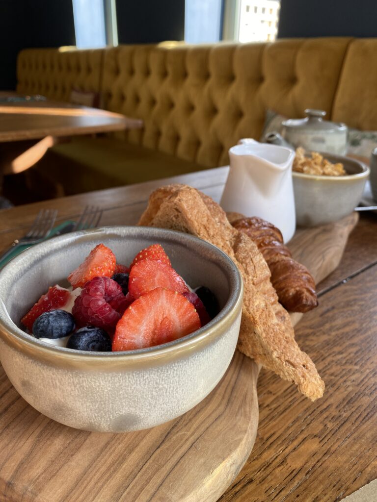 Continental breakfast at the Duke on the Test. Yoghurt with berries, cereal and milk, pastries, toast and butter and orange juice.