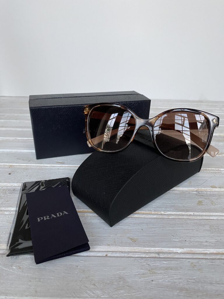 Ladies prada sunglasses, with case and cleaning cloth.
