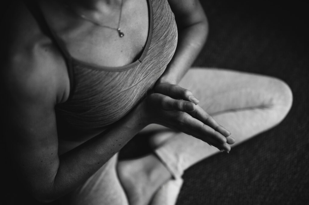 Person sitting in a yoga pose.